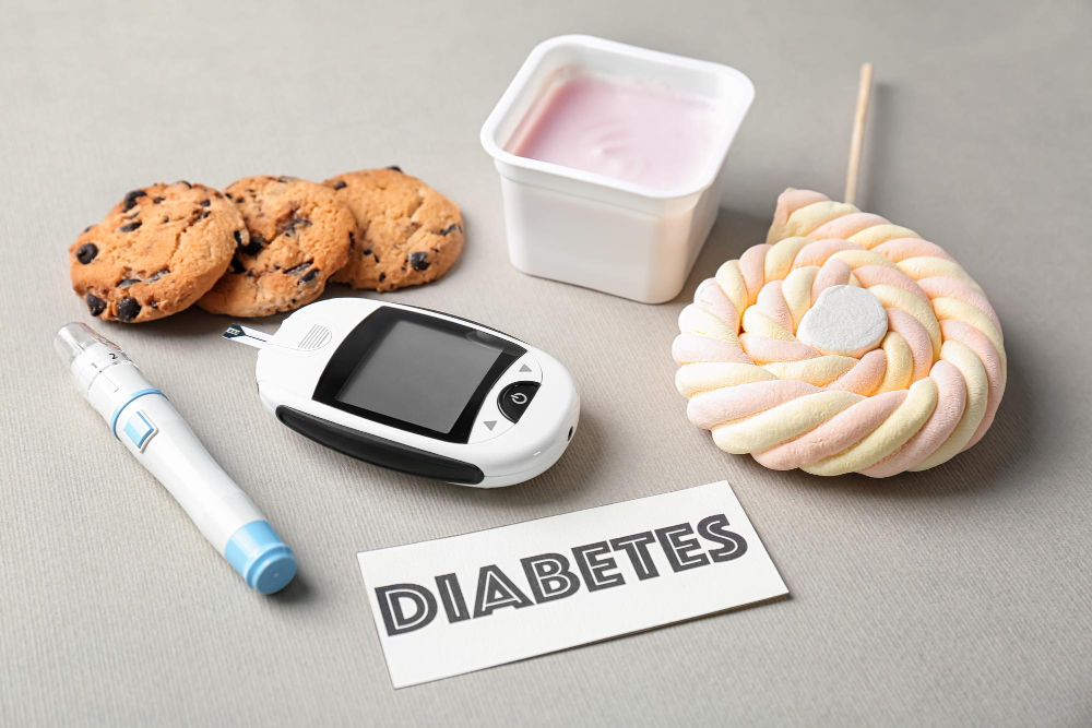 Composition with word Diabetes sweets and digital glucometer on light background